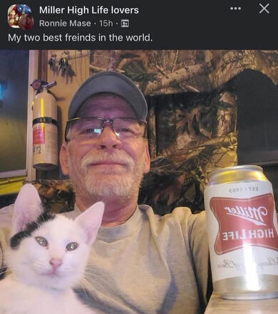 a screenshot from the facebook group "Miller High Life lovers." it is a picture of an older white man holding a miller-brand beer and a zoned-out white cat. the man is smiling and the caption reads "My two best freinds [sic] in the world."